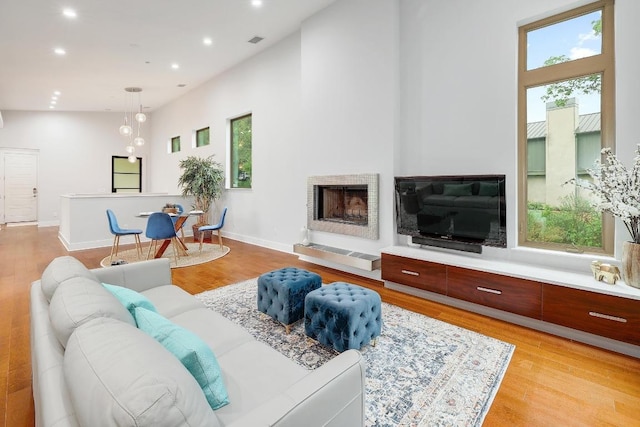 603 Westwood Ter, Austin, TX 78746 - living area featuring plenty of natural light, light wood-style flooring, recessed lighting, and a fireplace with raised hearth