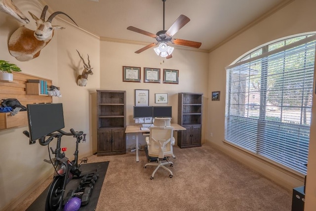 office space with ornamental molding, carpet, and a ceiling fan