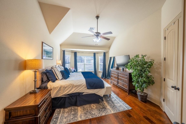 bedroom featuring visible vents, wood finished floors, baseboards, a ceiling fan, and vaulted ceiling