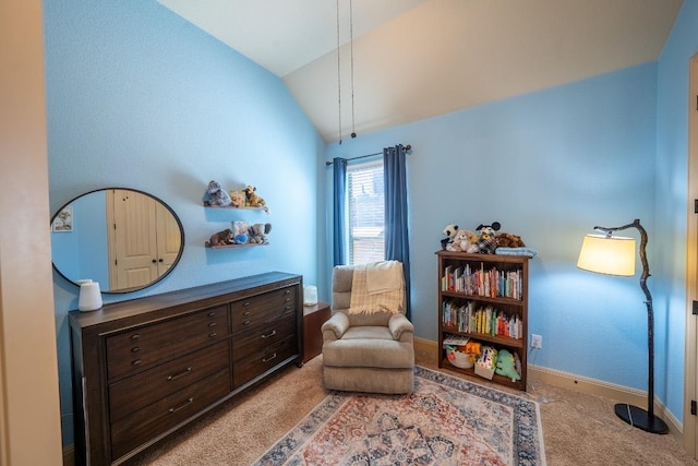 sitting room featuring carpet floors, baseboards, and vaulted ceiling