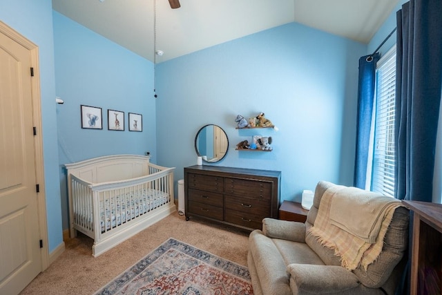 carpeted bedroom featuring baseboards, a ceiling fan, lofted ceiling, and a nursery area