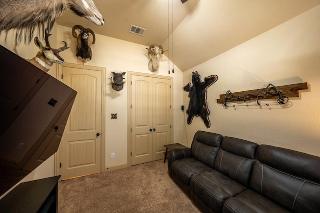 carpeted living room with visible vents and lofted ceiling