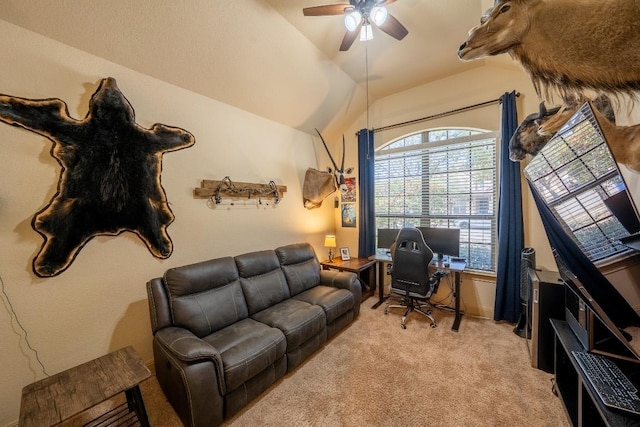living area with light colored carpet, ceiling fan, and vaulted ceiling