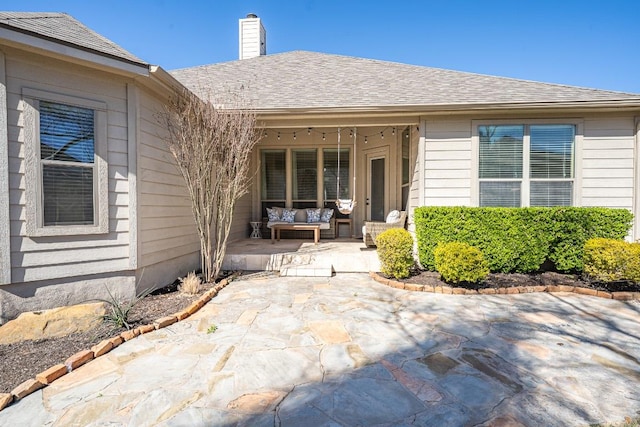 2705 Sixpence Ln, Pflugerville, TX 78660 - view of exterior entry with a chimney and a patio