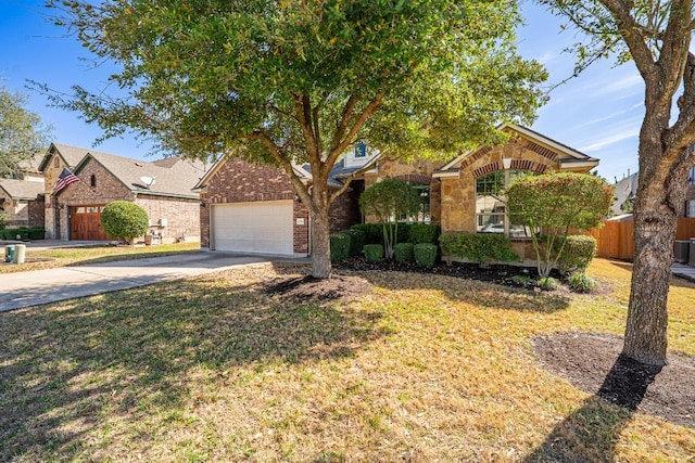 obstructed view of property with a garage, brick siding, fence, a front lawn, and concrete driveway