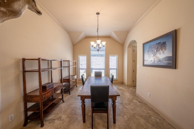 dining area with crown molding, arched walkways, vaulted ceiling, baseboards, and a chandelier