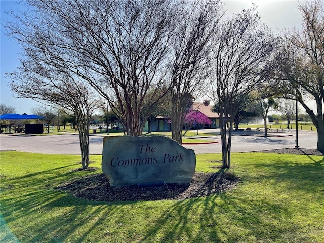 community sign featuring a yard