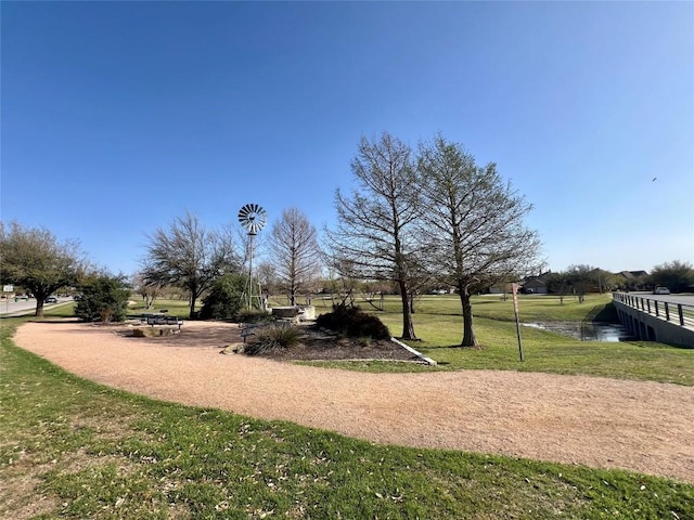 view of property's community with a lawn