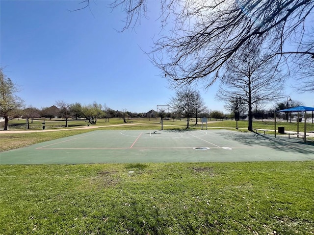 view of basketball court with a lawn and community basketball court