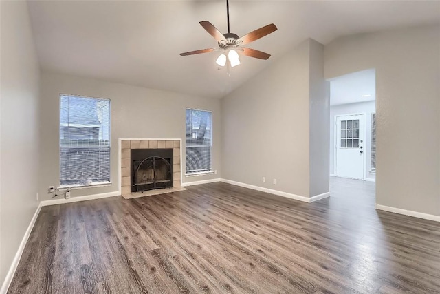 unfurnished living room featuring dark wood-style floors, ceiling fan, a wealth of natural light, and baseboards