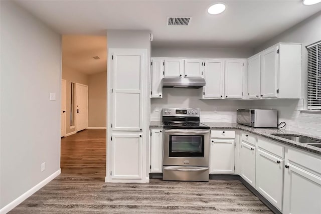 kitchen with white cabinets, visible vents, electric range, and under cabinet range hood