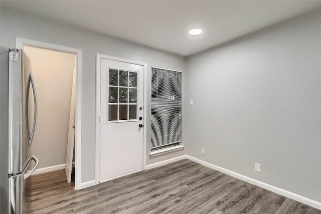 entryway featuring baseboards, recessed lighting, wood finished floors, and a heating unit