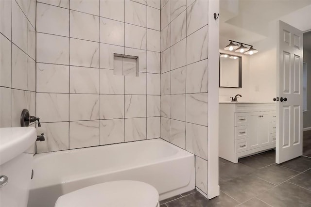 bathroom featuring tile patterned floors, vanity, toilet, and shower / bathtub combination