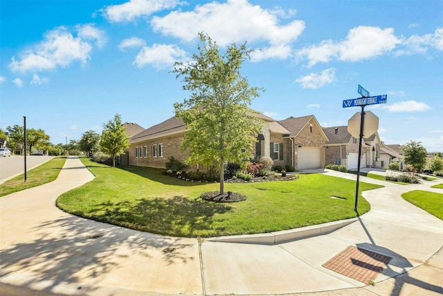 128 Mountain Lion Rd, Georgetown, TX 78628 - view of front of property with concrete driveway, a front lawn, brick siding, and a garage