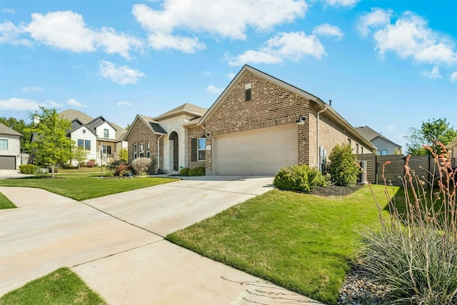 128 Mountain Lion Rd, Georgetown, TX 78628 - view of front of house with brick siding, an attached garage, driveway, and a residential view
