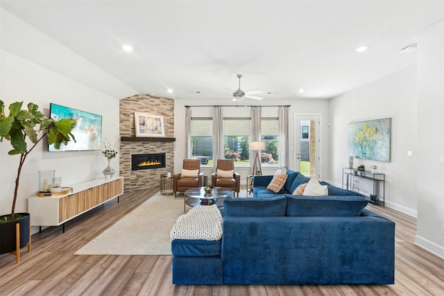 128 Mountain Lion Rd, Georgetown, TX 78628 - living area featuring a large fireplace, vaulted ceiling, a ceiling fan, wood finished floors, and recessed lighting