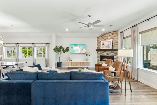 128 Mountain Lion Rd, Georgetown, TX 78628 - living room featuring light wood-style floors, ceiling fan, baseboards, a large fireplace, and vaulted ceiling