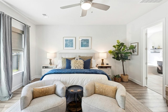 128 Mountain Lion Rd, Georgetown, TX 78628 - bedroom featuring wood finished floors, ensuite bathroom, and ceiling fan