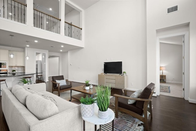 728 Pioneer Grv, Round Rock, TX 78665 - living room with a high ceiling, baseboards, dark wood finished floors, and recessed lighting