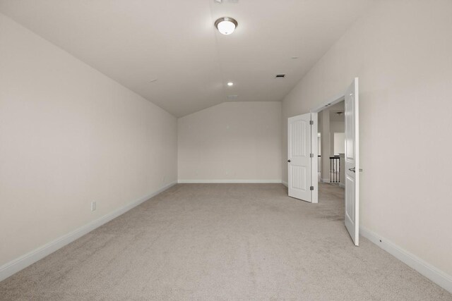 728 Pioneer Grv, Round Rock, TX 78665 - additional living space with light colored carpet, lofted ceiling, and baseboards