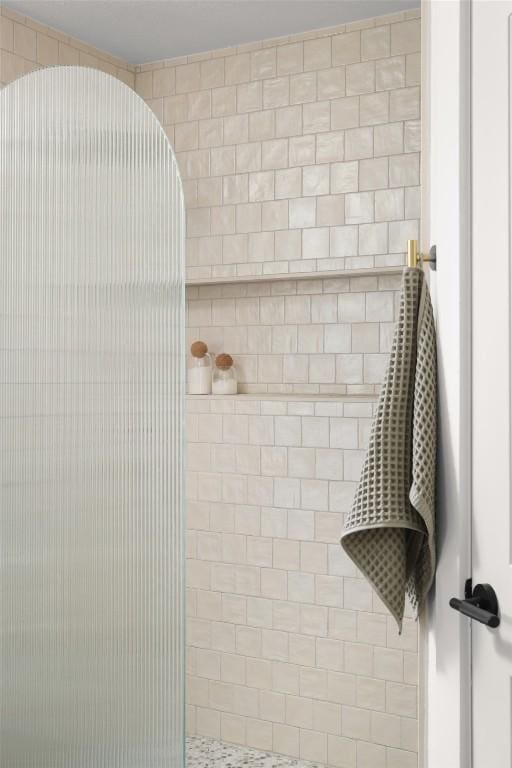 full bathroom with a tile shower