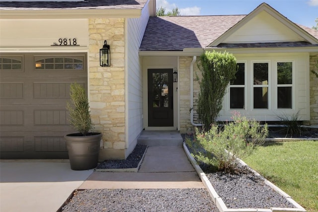 property entrance with stone siding, roof with shingles, and an attached garage