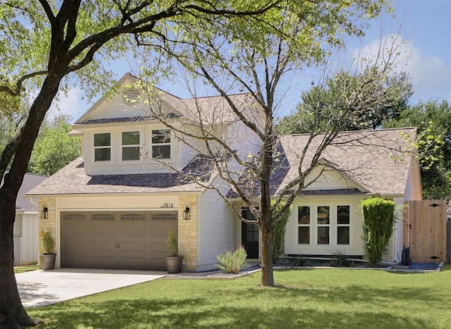view of front of home featuring concrete driveway, a shingled roof, and a garage