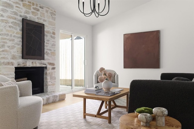 living room with a chandelier, a fireplace, wood finished floors, and lofted ceiling
