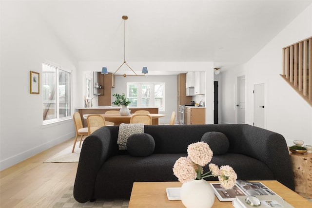living area with light wood finished floors and baseboards