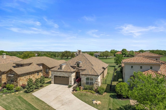 109 Grand Oaks Ln, Georgetown, TX 78628 - view of front of house with stone siding, driveway, a garage, stucco siding, and a tiled roof