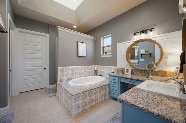 109 Grand Oaks Ln, Georgetown, TX 78628 - bathroom featuring vanity, a garden tub, tile patterned floors, and a skylight