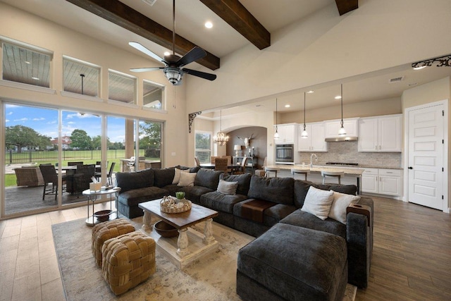 109 Grand Oaks Ln, Georgetown, TX 78628 - living room with beam ceiling, wood finished floors, ceiling fan, a towering ceiling, and recessed lighting