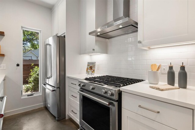 1605 Willow St Unit B, Austin, TX 78702 - kitchen featuring wall chimney exhaust hood, white cabinets, appliances with stainless steel finishes, and tasteful backsplash