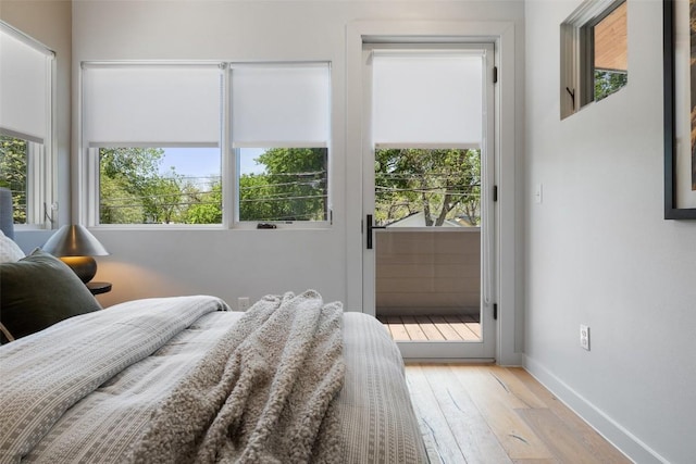 1605 Willow St Unit B, Austin, TX 78702 - bedroom featuring wood-type flooring, access to exterior, and baseboards