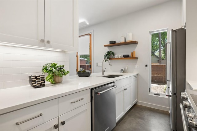 1605 Willow St Unit B, Austin, TX 78702 - kitchen featuring a sink, white cabinetry, finished concrete flooring, decorative backsplash, and appliances with stainless steel finishes