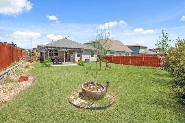 back of property with a patio, a fenced backyard, and a lawn