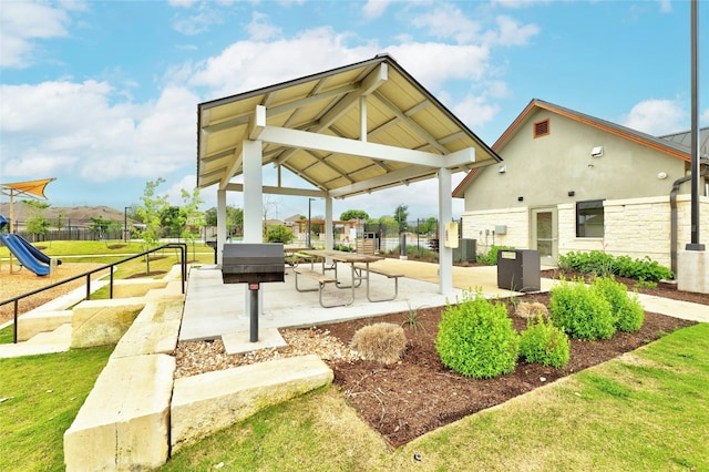 view of home's community with fence, a gazebo, and playground community