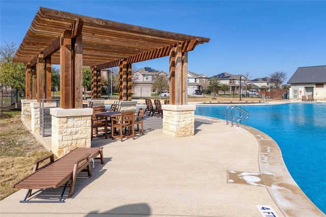 community pool with a residential view, a pergola, fence, and a patio area