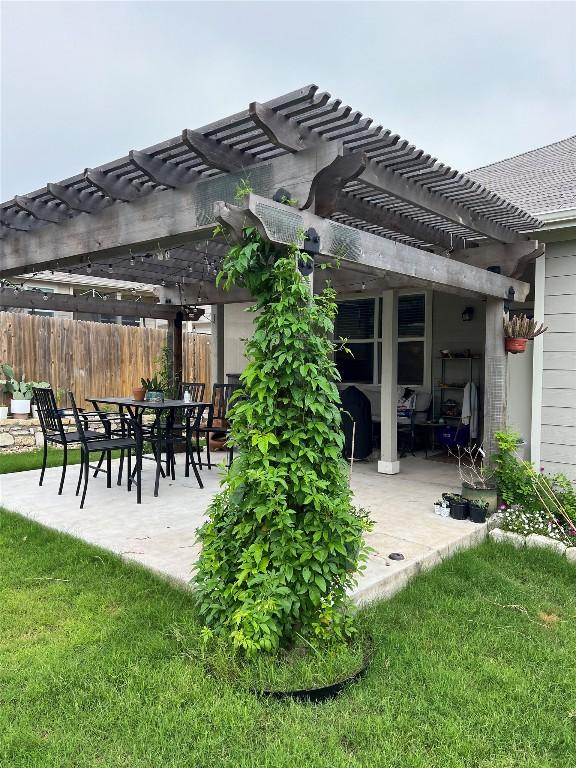 view of patio / terrace with fence and a pergola