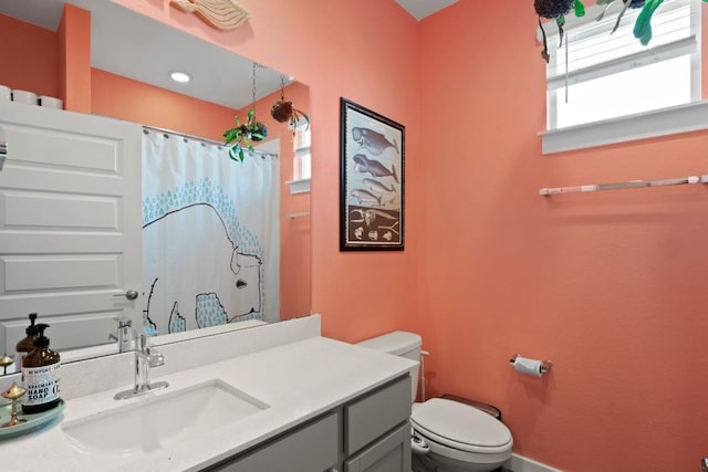 full bath featuring toilet, a shower with curtain, and vanity