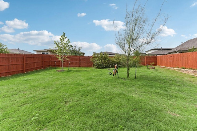 view of yard with a fenced backyard
