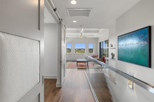 hall featuring a barn door, visible vents, recessed lighting, coffered ceiling, and hardwood / wood-style floors