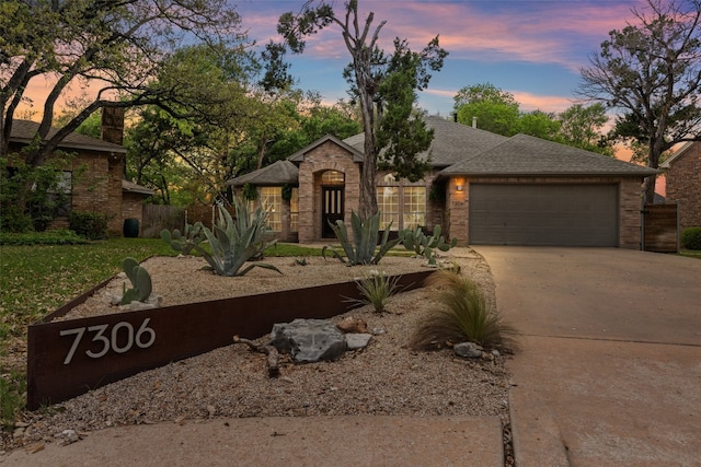 7306 Holly Fern Cv, Austin, TX 78750 - view of front of property featuring driveway, a garage, and brick siding
