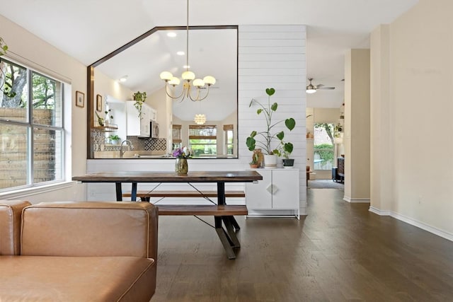 7306 Holly Fern Cv, Austin, TX 78750 - dining room featuring dark wood-type flooring, a chandelier, healthy amount of natural light, vaulted ceiling, and a ceiling fan
