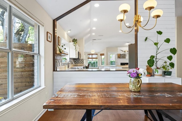 7306 Holly Fern Cv, Austin, TX 78750 - dining room with a chandelier, lofted ceiling, wood finished floors, and recessed lighting