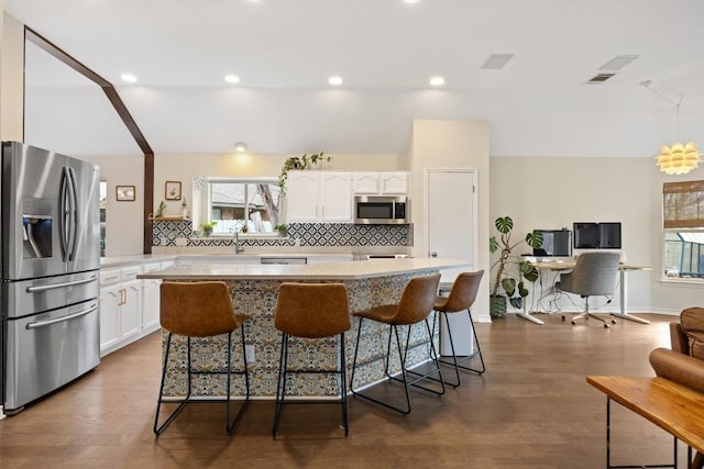 7306 Holly Fern Cv, Austin, TX 78750 - kitchen featuring stainless steel appliances, white cabinets, tasteful backsplash, plenty of natural light, and recessed lighting