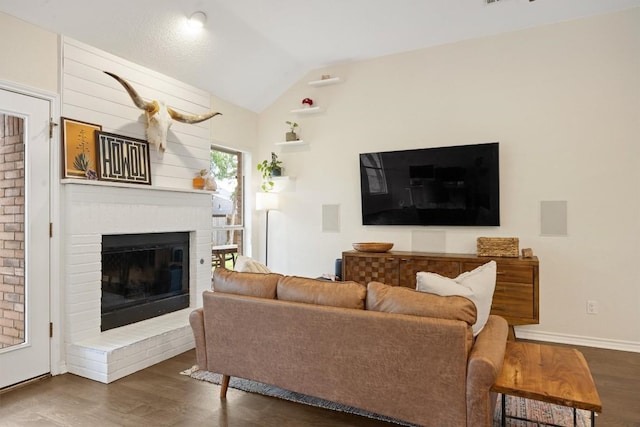 7306 Holly Fern Cv, Austin, TX 78750 - living area with wood finished floors, a brick fireplace, and vaulted ceiling