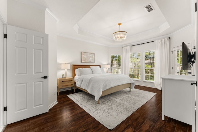6 Dovedale Cv, The Hills, TX 78738 - bedroom with a tray ceiling, crown molding, dark wood-type flooring, and a chandelier