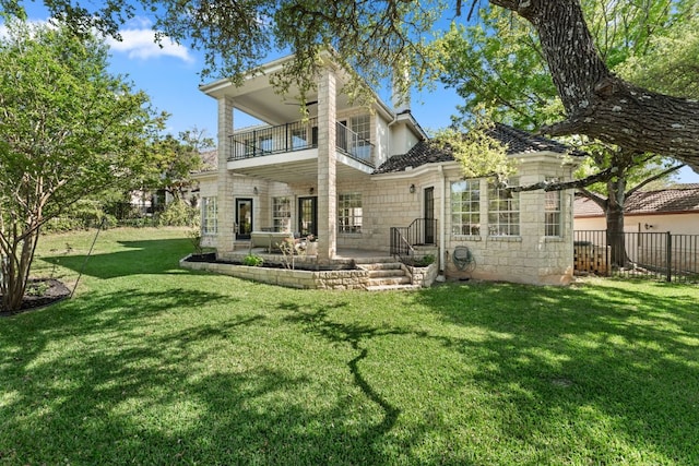 6 Dovedale Cv, The Hills, TX 78738 - back of house featuring a balcony, a patio area, and stone siding