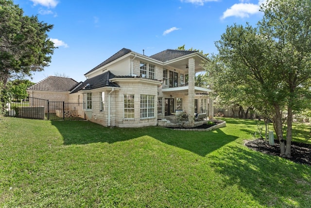 6 Dovedale Cv, The Hills, TX 78738 - rear view of house featuring a balcony, a ceiling fan, a fenced backyard, stone siding, and a patio area